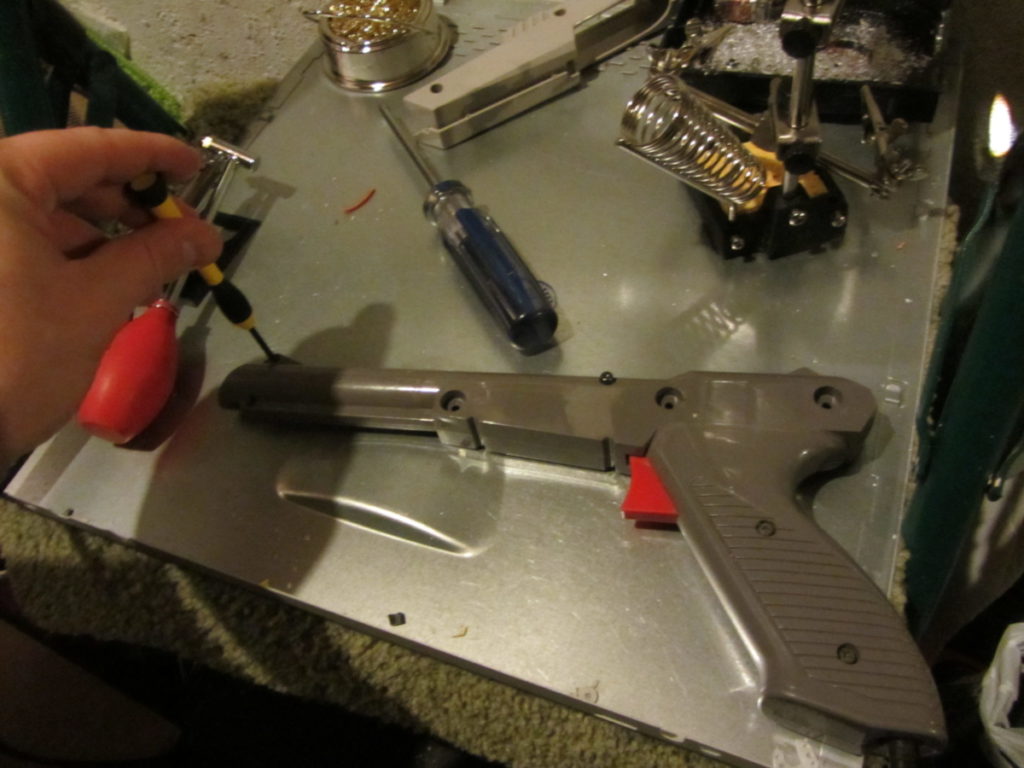 Unscrew the smaller screw near the sight marker