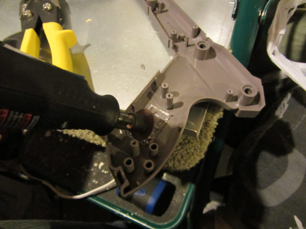 Using a Dremel power tool to smooth out the weight holder